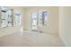 Bright living room with windows and a door to a balcony, hardwood floors, and neutral-colored walls at 641 Skyhook St, Erie, CO 80516