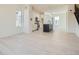 Open floor plan with modern kitchen featuring white cabinets, an island, and view to a bright living space at 641 Skyhook St, Erie, CO 80516