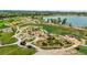 Beautiful aerial view of a community park with playground, bike track, and a serene lake in the background at 2027 Vallejo Loop, Broomfield, CO 80023