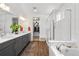 Modern Primary bathroom with double vanity, wood floor, and glass-enclosed shower at 2027 Vallejo Loop, Broomfield, CO 80023