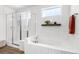 Bright bathroom featuring soaking tub with tile surround and glass-enclosed shower at 2027 Vallejo Loop, Broomfield, CO 80023