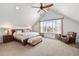 Vaulted ceiling Primary bedroom featuring a ceiling fan, a large window, and an upholstered bench at 2027 Vallejo Loop, Broomfield, CO 80023