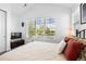 Comfortable bedroom offering a bed with bright pillows, sun-drenched windows, and television at 2027 Vallejo Loop, Broomfield, CO 80023