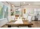 Open concept dining room with a rustic wood table and contemporary lighting fixture at 2027 Vallejo Loop, Broomfield, CO 80023