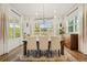 Bright dining room featuring a modern light fixture, large windows, and a stylish rug at 2027 Vallejo Loop, Broomfield, CO 80023