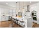 Open kitchen with a large island, modern appliances, and hardwood flooring, perfect for entertaining at 2027 Vallejo Loop, Broomfield, CO 80023