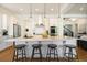Spacious kitchen featuring a large island, stainless steel appliances, and elegant pendant lighting at 2027 Vallejo Loop, Broomfield, CO 80023