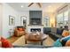 Stylish living room showcasing a fireplace, comfortable seating, and a modern ceiling fan at 2027 Vallejo Loop, Broomfield, CO 80023
