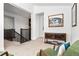 Upstairs landing with a display cabinet, cozy chairs, and elegant stairs at 2027 Vallejo Loop, Broomfield, CO 80023