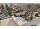 Aerial view of a well-maintained ranch-style home with mature trees and a long driveway at 32 Skyline Dr, Wheat Ridge, CO 80215