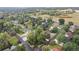 Aerial view showcasing a neighborhood with mature trees and landscaping with homes and green spaces at 32 Skyline Dr, Wheat Ridge, CO 80215