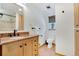 Bathroom boasts a sink with a wooden cabinet, modern toilet and a shower in the corner at 32 Skyline Dr, Wheat Ridge, CO 80215