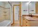Bathroom boasts a shower and bathtub, wooden cabinets and a sink at 32 Skyline Dr, Wheat Ridge, CO 80215
