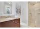 Bathroom with granite countertops, a glass shower, and modern fixtures at 32 Skyline Dr, Wheat Ridge, CO 80215