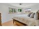 Bright bedroom with hardwood floors, two windows and a ceiling fan at 32 Skyline Dr, Wheat Ridge, CO 80215