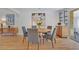 Elegant dining area with modern furniture, artwork and hardwood floors at 32 Skyline Dr, Wheat Ridge, CO 80215
