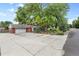 View of the home showing a large driveway and side-entry garage at 32 Skyline Dr, Wheat Ridge, CO 80215