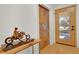 Bright entryway with hardwood floors, a rustic sliding door, and a view through the glass front door at 32 Skyline Dr, Wheat Ridge, CO 80215