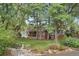 Exterior view featuring mature trees and manicured lawn at 32 Skyline Dr, Wheat Ridge, CO 80215