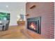 Modern brick fireplace featuring a black metal surround in a bright living room at 32 Skyline Dr, Wheat Ridge, CO 80215