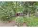 Lovely home exterior surrounded by mature trees and lush greenery at 32 Skyline Dr, Wheat Ridge, CO 80215