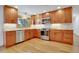 Well-lit kitchen featuring custom cabinets, stainless steel appliances, and hardwood floors at 32 Skyline Dr, Wheat Ridge, CO 80215