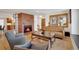 Inviting living room with a brick fireplace, hardwood floors, and ample seating at 32 Skyline Dr, Wheat Ridge, CO 80215