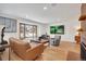 Bright living room with hardwood floors, large windows, stylish furniture, and modern art at 32 Skyline Dr, Wheat Ridge, CO 80215
