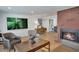 Spacious living room with modern decor, brick fireplace, and hardwood floors at 32 Skyline Dr, Wheat Ridge, CO 80215