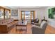 Cozy living room featuring hardwood floors, a bay window, and comfortable seating arrangement at 32 Skyline Dr, Wheat Ridge, CO 80215