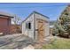 A backyard shed with gray siding, a wood door, and a small window adding character to the outdoor space at 32 Skyline Dr, Wheat Ridge, CO 80215