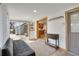 Bright sun room features sliding glass doors, hardwood floors and access to the kitchen at 32 Skyline Dr, Wheat Ridge, CO 80215