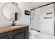 Bright bathroom with granite countertop and sliding glass shower doors at 100 Park W Ave # 1403, Denver, CO 80205