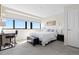 Bright bedroom featuring a large window with views and a work desk at 100 Park W Ave # 1403, Denver, CO 80205