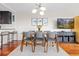 Dining area with stylish light fixture, mountain paintings, and seating for six at 100 Park W Ave # 1403, Denver, CO 80205