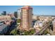 Stunning high-rise building with balconies offering panoramic city views and mountain views in the background at 100 Park W Ave # 1403, Denver, CO 80205