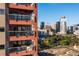 Stunning exterior view of the building featuring balconies and a beautiful city skyline backdrop at 100 Park W Ave # 1403, Denver, CO 80205