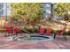 Inviting outdoor hot tub surrounded by red lounge chairs and landscaping for a relaxing experience at 100 Park W Ave # 1403, Denver, CO 80205