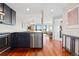 Modern kitchen design with stainless steel dishwasher and sink open to living area at 100 Park W Ave # 1403, Denver, CO 80205