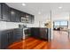 Modern kitchen with stainless steel appliances and dark cabinetry, with hardwood floors at 100 Park W Ave # 1403, Denver, CO 80205