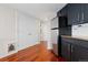 Efficiency kitchen featuring stainless steel refrigerator, dark cabinetry and hardwood flooring at 100 Park W Ave # 1403, Denver, CO 80205