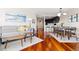 Open living space with hardwood floors, modern lighting, and a view into the kitchen at 100 Park W Ave # 1403, Denver, CO 80205