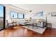 Inviting living room with large window, hardwood floors, and comfortable seating at 100 Park W Ave # 1403, Denver, CO 80205