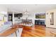 Bright open living space featuring hardwood floors, dining area, modern kitchen, and entertainment setup at 100 Park W Ave # 1403, Denver, CO 80205