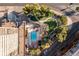 Aerial view showcasing the pool and lush green courtyard area with trees, lounge chairs, and walkways at 100 Park W Ave # 1403, Denver, CO 80205