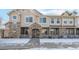 Inviting townhome exterior featuring stone accents, covered entryway, and well-maintained landscaping in a peaceful community at 10050 E Gunnison Pl # 805, Aurora, CO 80247