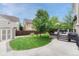 Backyard with a manicured lawn, wooden fence, deck and patio area, and a storage shed at 5625 S Buchanan St, Aurora, CO 80016