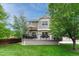 Large backyard deck with an umbrella table and chairs, ideal for outdoor gatherings and relaxation at 5625 S Buchanan St, Aurora, CO 80016