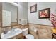Charming half-bathroom features decorative tile work, modern fixtures, and stylish decor at 5625 S Buchanan St, Aurora, CO 80016