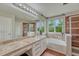 Bathroom with tub, walk-in shower, large mirror, and tile flooring at 5625 S Buchanan St, Aurora, CO 80016